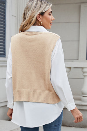 Tan cable knit sweater vest with ribbed hem, layered over a white collared shirt.