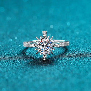 Sterling silver ring with a starburst center stone and pavé band.