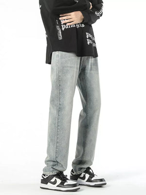 Classic loose fit vintage denim jeans in light wash cotton, styled with a black graphic tee.