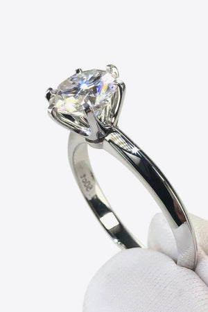 Silver engagement ring with a brilliant cut moissanite solitaire stone.