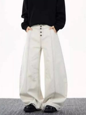 Relaxed fit wide leg button-fly jeans in cream cotton with contrast stitching.