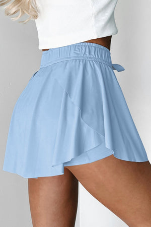 Light blue ruffled skort with tie waist detail and elastic waistband.