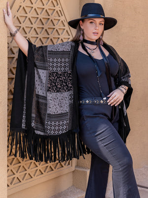 Black patchwork print kimono with fringe detail and boho styling.