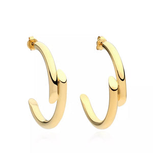 Gold sculptural C-hoop earrings with a contemporary design.