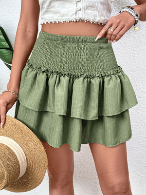 Tiered ruffle mini skirt in matcha green with a smocked waist and textured fabric.