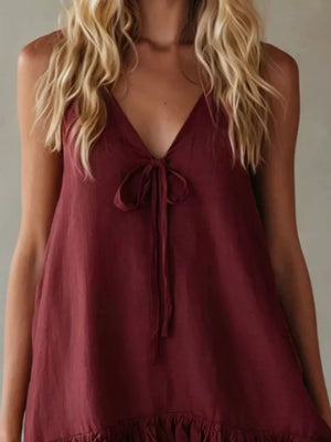 Burgundy tie-front mini dress with V-neck and ruffle hem.