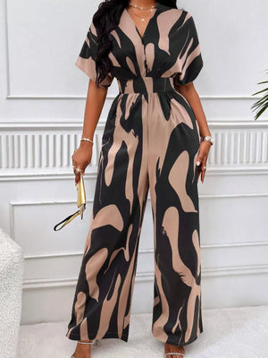 Chic abstract print wide-leg romper in black and khaki with short sleeves and V-neck.