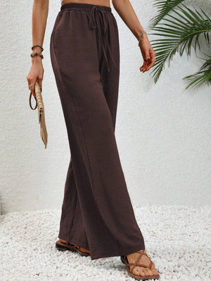 Dark brown textured palazzo trousers with drawstring waist and wide leg