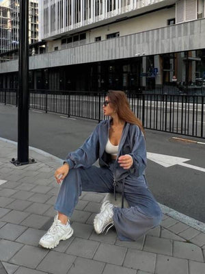 Plush velour lounge set in blue with wide leg pants and zip-up hoodie.
