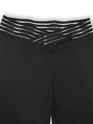 Black flare leggings with a crossover waistband featuring striped elastic detail