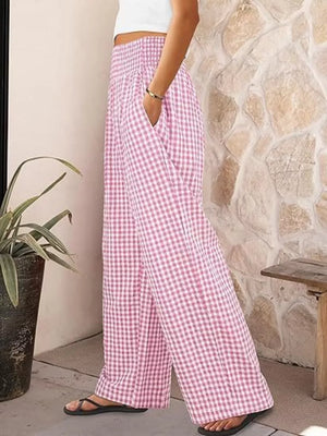 Pink plaid gingham maternity pants with smocked waistband and wide legs.