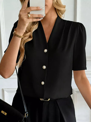 Black V-neck button-down shirt with pearl buttons and short puff sleeves.