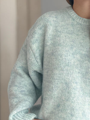 Light green oversized crewneck sweater with textured knit and speckled detail.