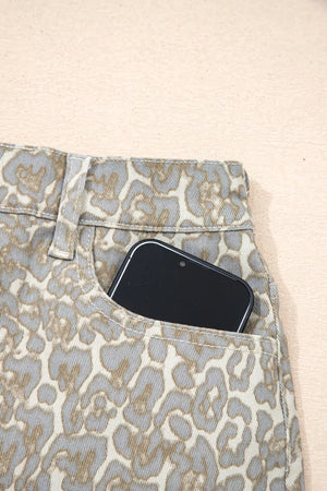 Denim shorts with leopard print and a phone in the pocket.