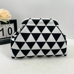 Vibrant knit clutch with striking black and white triangle pattern