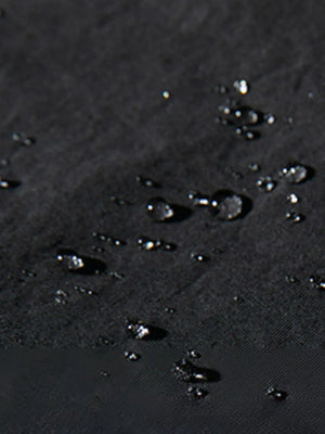 Black oversized cargo trousers with water droplets on fabric