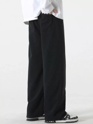 Black relaxed fit drawstring pants with side pockets, shown on a model.