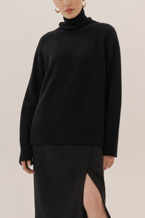 Black cashmere turtleneck sweater with raglan sleeves and ribbed trim.
