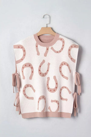 White knit tank top with pink horseshoe pattern and side ties.