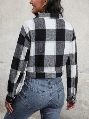 Checked plaid shacket in black and white with buttoned cuffs.
