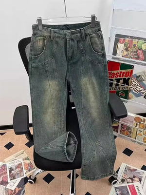 Men's vintage-inspired flare jeans in faded grey denim with curved seams and a relaxed fit.