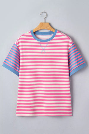 Short sleeve t-shirt with pink and white horizontal stripes, blue striped sleeves, and blue crew neck.