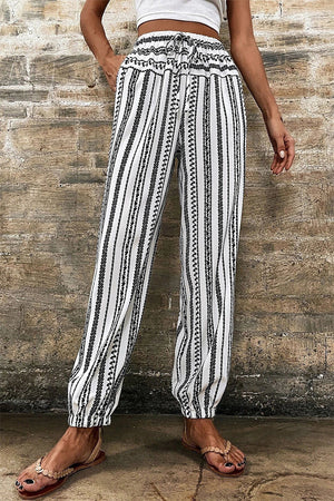 Embroidered stripe drawstring joggers with elastic cuffs and a relaxed fit.