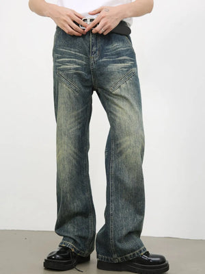 Vintage wash flare leg jeans in medium blue denim with distressed details and angled front pockets.