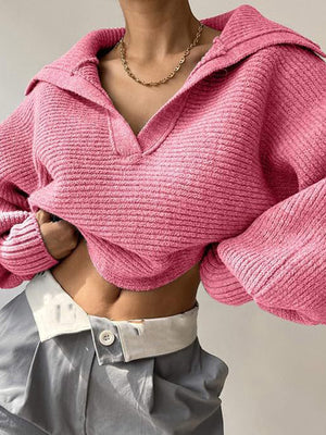 Pink knit sweater with wide collar and balloon sleeves, cropped length.