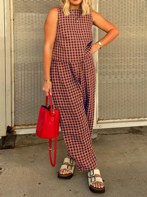 Gingham cropped tank and tapered trousers set in rust and navy, styled with a red bucket bag.