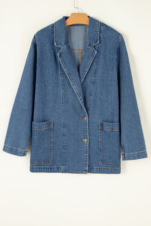 Medium wash denim double-breasted blazer with two button closure and flap pockets.