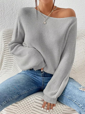 Light gray asymmetrical knit sweater with off-shoulder neckline and balloon sleeves.