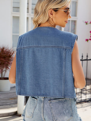 Boxy denim vest in Dusty Blue with buttoned front and patch pockets, styled casually.