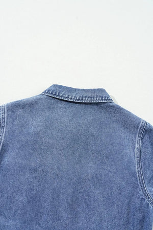 Medium wash denim romper with button-down collar and elastic waist detail.