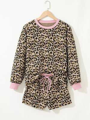 Leopard print loungewear set with pink trim, crew neck sweatshirt and drawstring shorts.