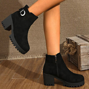 Black suede ankle boots with round toe, block heel, decorative buckle and side zipper.