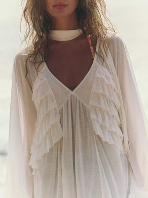 White sheer ruffle trim beach cover-up with deep V-neck and long sleeves.