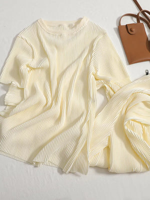Apricot pleated two-piece set with round neck top and flowing pants.