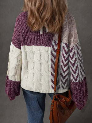Patchwork cable knit sweater in mauve with cream and light pink panels and chevron pattern.