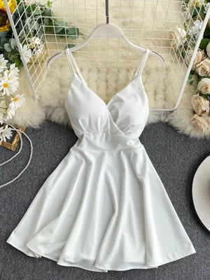 White V-neck spaghetti strap mini dress with adjustable straps and a flared skirt.