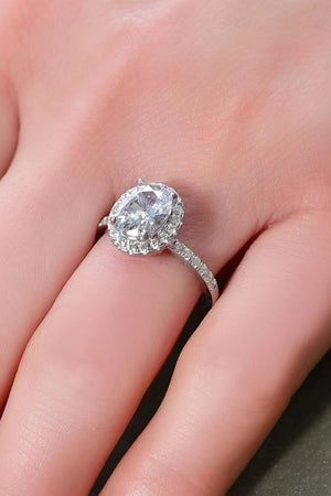 White halo oval diamond engagement ring with pave band