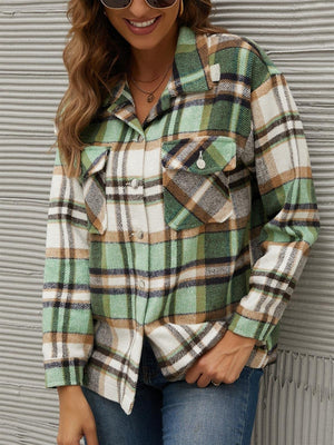 Green plaid collared long sleeve jacket with buttoned chest pockets.