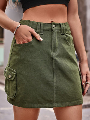 Army green denim mini skirt with cargo pockets and a button fly.