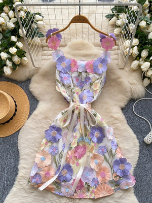 Embroidered floral mini dress with colorful 3D flowers and a ribbon bow waist.