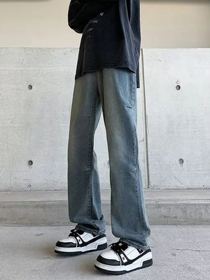Men's vintage wash wide-leg jeans in light blue denim, relaxed fit.