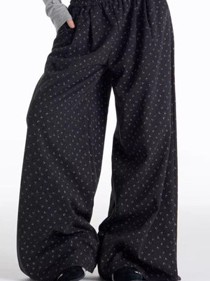 Men's relaxed fit black wide leg sweatpants with a subtle floral pattern.