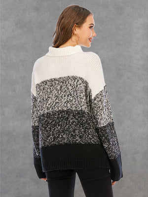 Colorblock turtleneck sweater with defined panels in white, black, and grey acrylic knit.