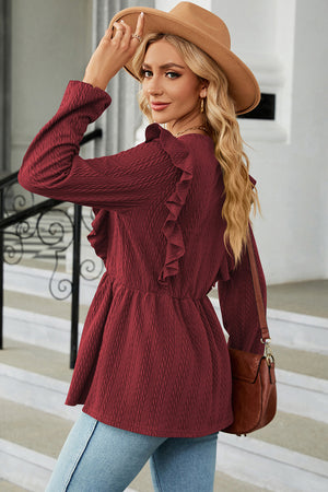 Burgundy textured peplum blouse with ruffle detail and long sleeves