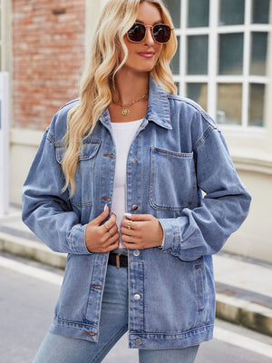 Medium blue denim oversized shacket with button-down front and chest pockets.