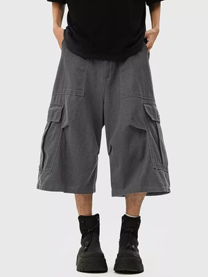 Relaxed fit dark gray cargo cropped sweatpants with multiple pockets and raw hem.